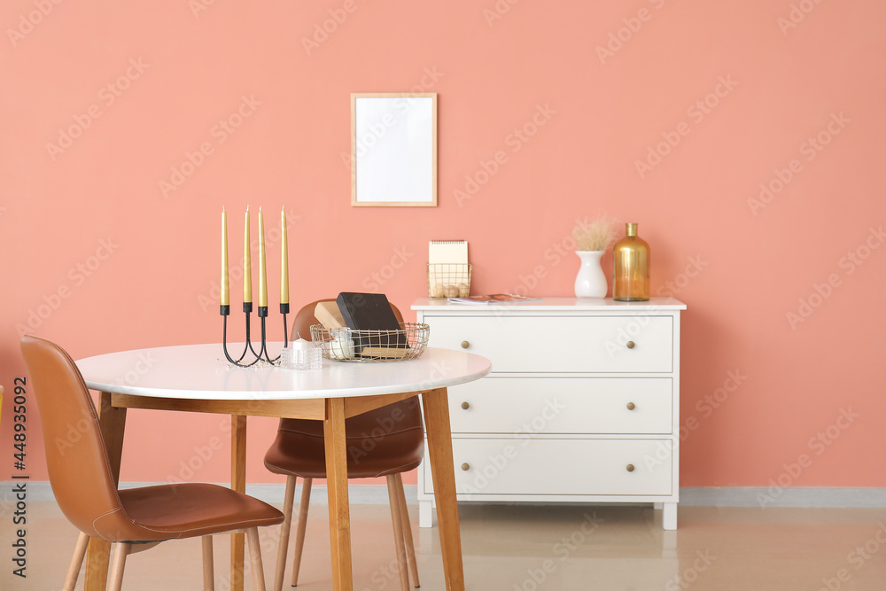 Fototapeta premium Aroma candles and books on table in room