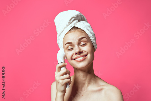 woman with towel on head cleaning skin therapy cosmetics technology