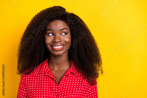 Photo of nice optimistic brunette lady look empty space wear red top isolated on vivid yellow color backgound © deagreez