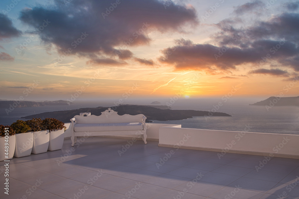 Wedding decoration on Santorini Island, a popular wedding destination in Greece. Elegant wedding with sunset view, colorful sky clouds background of ocean and blue sky. Beautiful wedding sunset