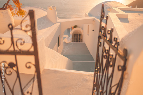 Fototapeta Naklejka Na Ścianę i Meble -  Santorini island sunset view. Architectural details, famous travel destination, abstract closeup view of streets in warm sunset light. Iron gate and white architecture, idyllic view, romantic scenery