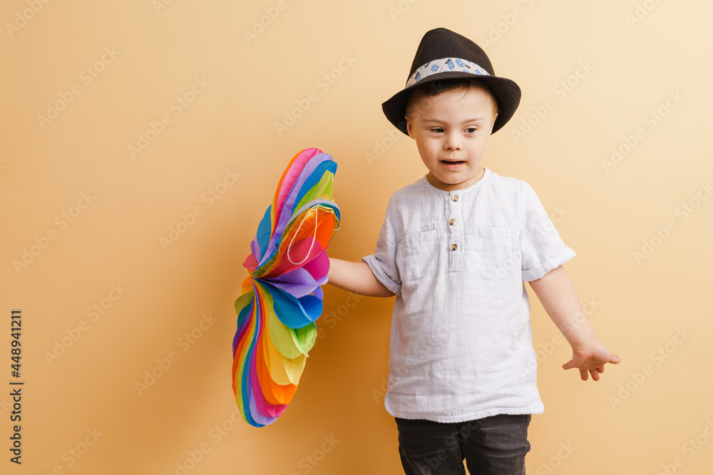White boy with down syndrome in hat posing with toy White boy with down syndrome in hat posing with toy