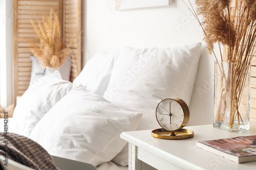 Stylish alarm clock on tabl...