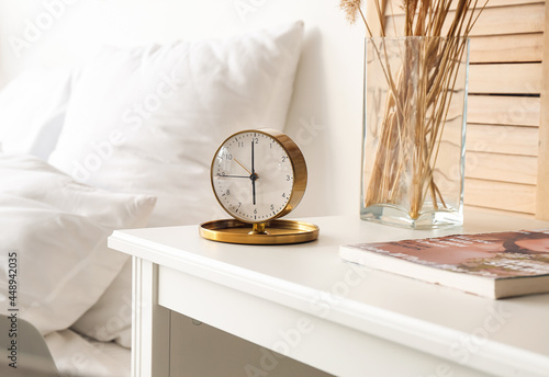 Stylish alarm clock on tabl...