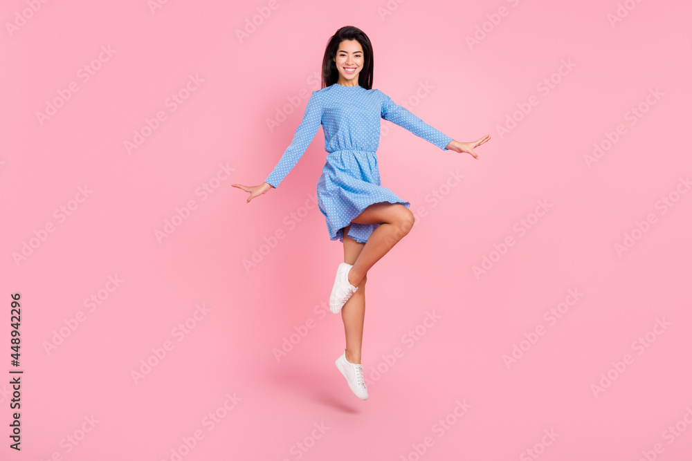 Full length profile side photo of young cheerful girl happy positive smile jump up isolated over pink color background Full length profile side photo of young cheerful girl happy positive smile jump up isolated over pink color background