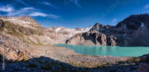 Fototapeta Naklejka Na Ścianę i Meble -  Panoramic View of Vibrant Colorful Glacier Lake up in Rocky Mountains in Canadian Nature Landscape. Sunny Summer Evening. Wedgemount Lake Hike in Whistler, British Columbia, Canada.