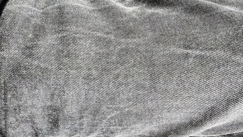 stone washed jeans. Denim fabric texture on black and white. Copy space photo