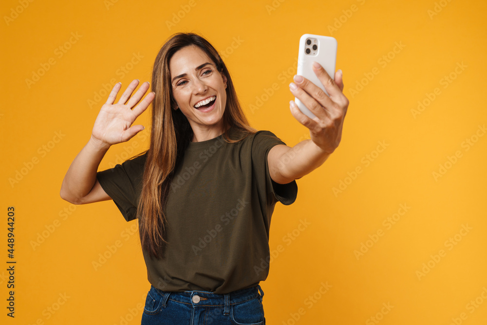 Happy mid aged casual woman taking selfie Happy mid aged casual woman taking selfie