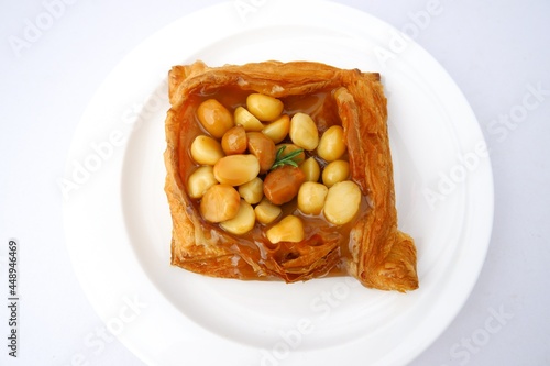 Bread, sachet on delicious Acadimia seeds on white plate isolated on white background. photo