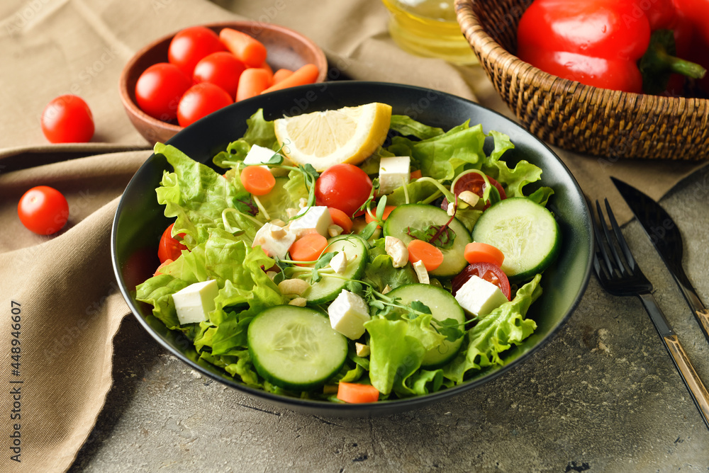 Plate of delicious fresh vegetable salad on table Plate of delicious fresh vegetable salad on table