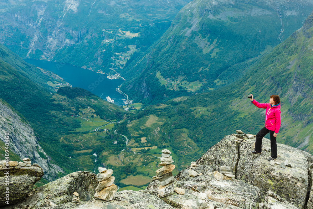 Fototapeta premium Tourist taking photo from Dalsnibba viewpoint Norway