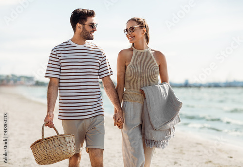 Wall Mural leisure, relationships and people concept - happy couple with picnic basket and