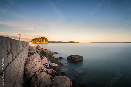 Coastline and city wall of Island and town of Rab in Croatia with long exposure