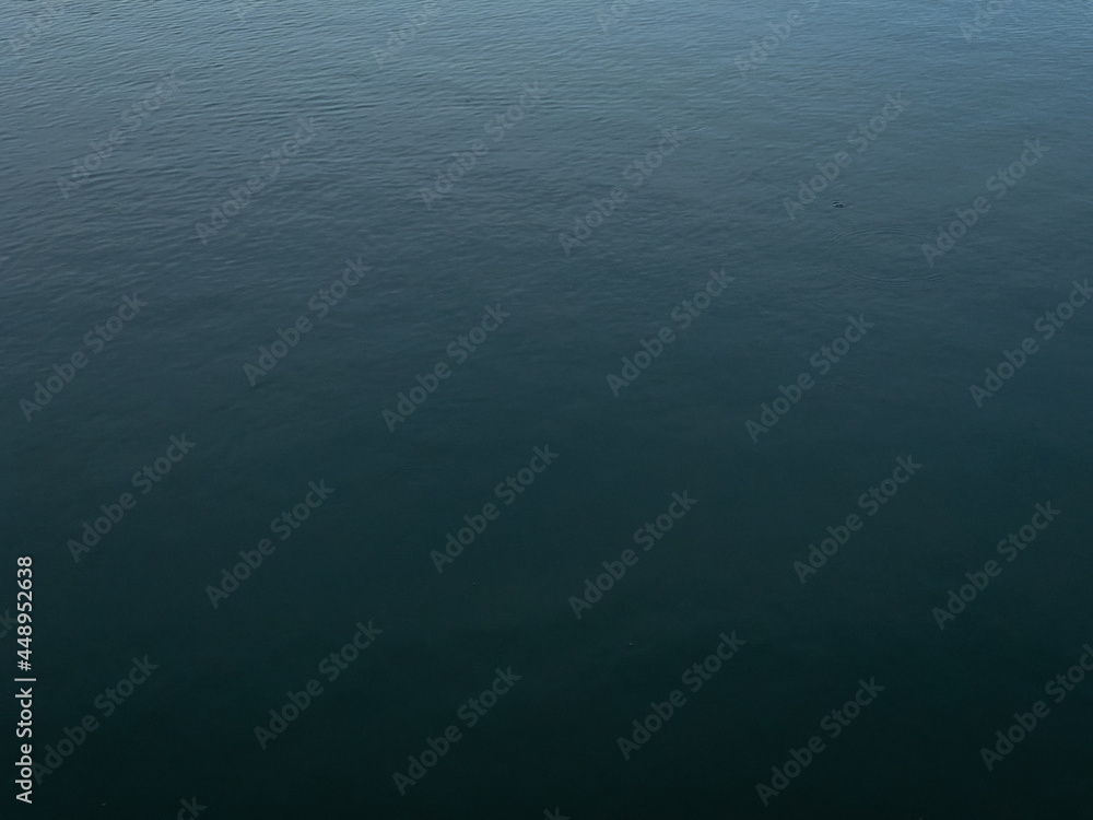 Dark deep blue Waves ripple claming Lake background