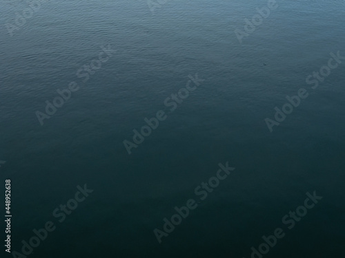 Dark deep blue Waves ripple claming Lake background