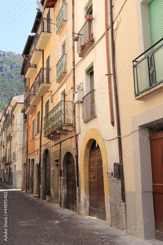 Fototapeta Naklejka Na Ścianę i Meble -  Antrodoco Street View with House Facades, Arched Doors and Iron Balconies, Central Italy