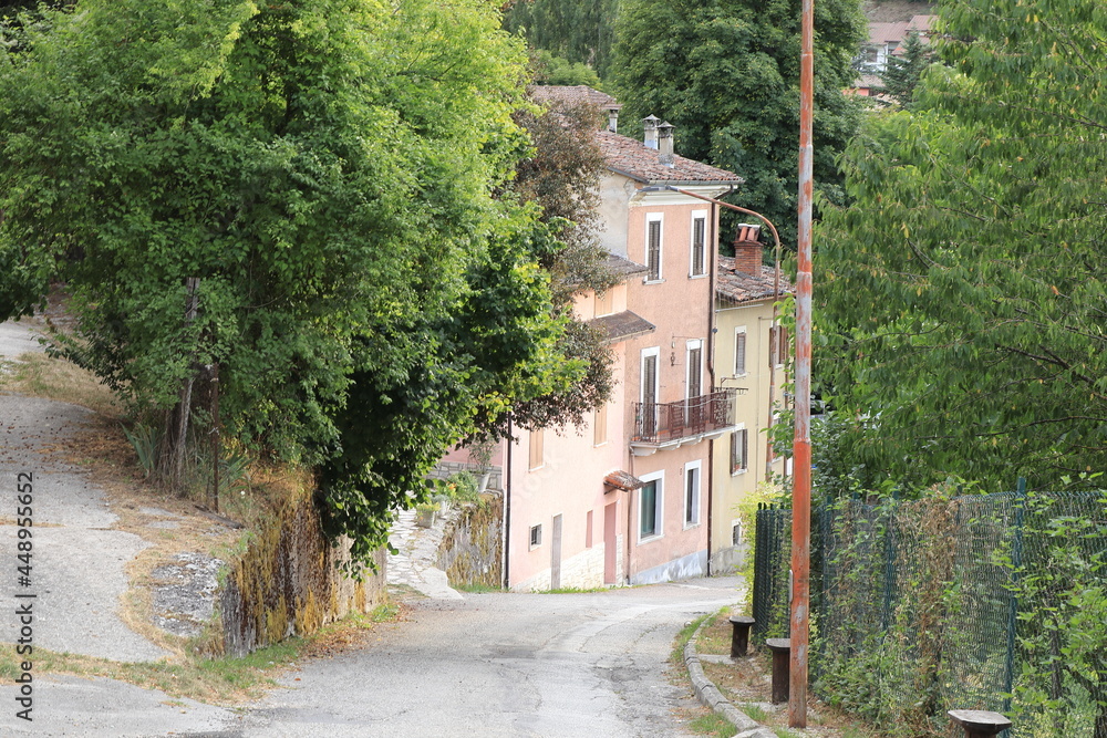 Rural Village Street View with House Facades and Foliage in Central Italy