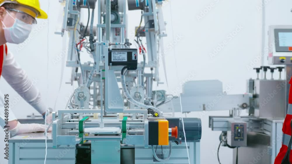 Quality control (QC) engineer monitoring and checking machine system in manufacturing factory Quality control (QC) engineer monitoring and checking machine system in manufacturing factory
