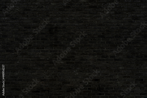 Black brick wall texture. Building architectural background.