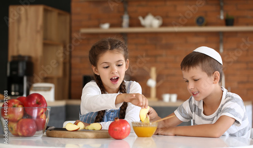 Canvas Print Little children celebrating Rosh Hashanah (Jewish New Year) at home