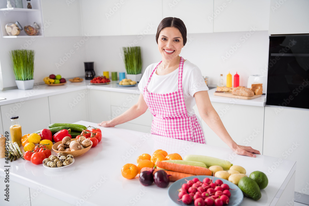 Photo of optimistic brunette hair young lady cook wear white t-shirt apron at kitchen