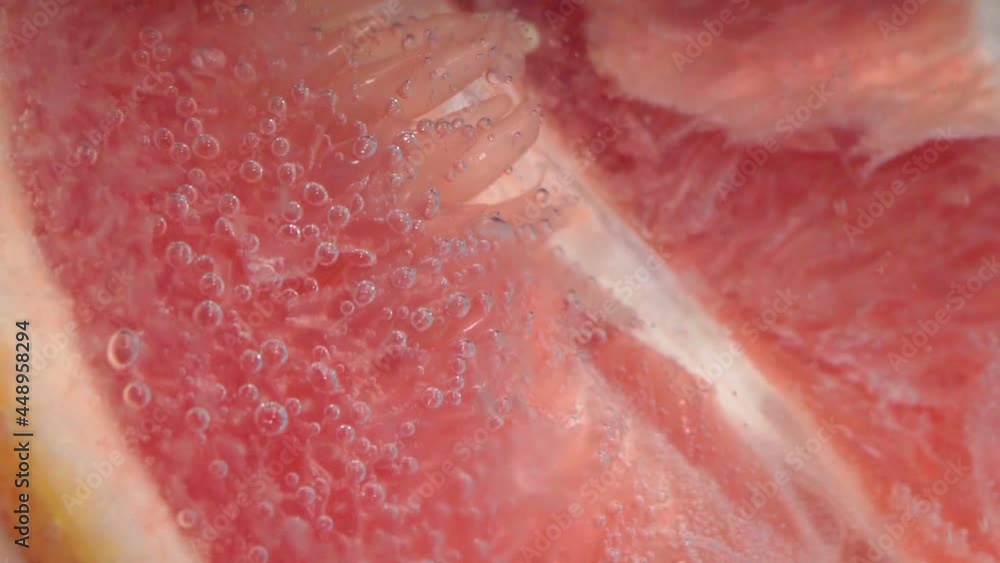 Grapefruit close up macro fizzing or floating up to top of surface. Grapefruit close up macro fizzing or floating up to top of surface.