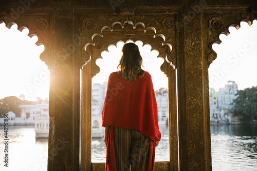 Western woman standing on a cultural architecture in Udaipur, India