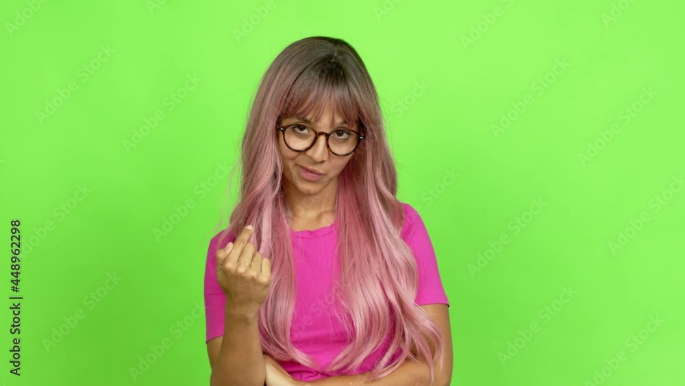 Young woman with pink hair with glasses presenting and inviting to come with hand over isolated background. On green screen chroma key Young woman with pink hair with glasses presenting and inviting to come with hand over isolated background. On green screen chroma key