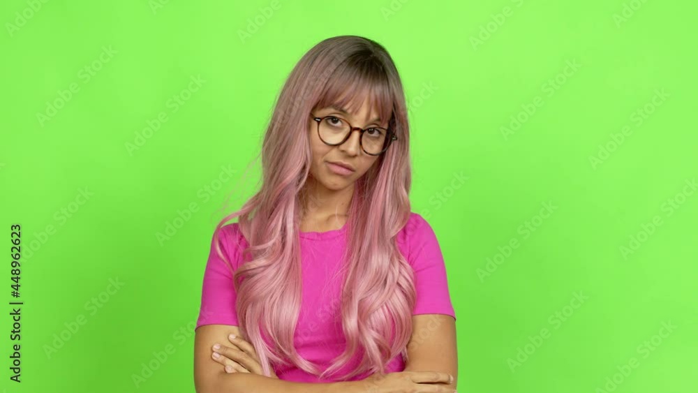 Young woman with pink hair with glasses. Portratit over isolated background. On green screen chroma key Young woman with pink hair with glasses. Portratit over isolated background. On green screen chroma key