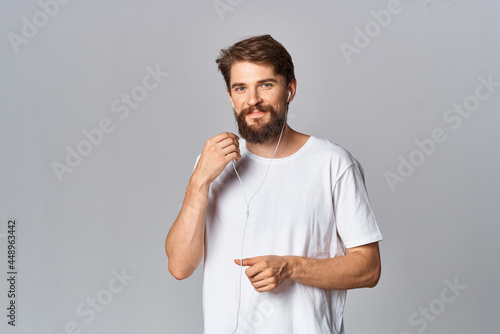 cute bearded man in t-shirt posing light background