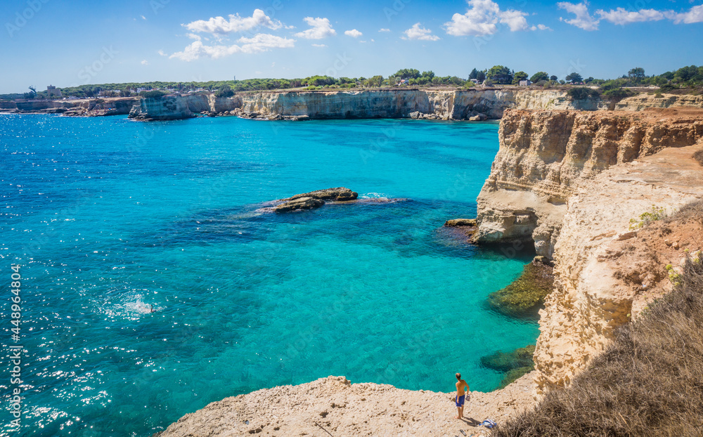 Torre Sant Andrea, Salento sea coast, Apulia, Italy. Faraglioni Melendugno. Beautiful rocky beach with cliffs in Puglia. Blue turquoise saturated clear water. Bright Summer day.