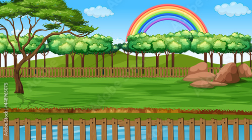 Park landscape scene with rainbow in the sky