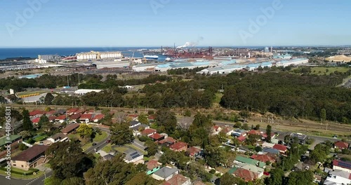 Green belt around Port Kembla industrial area of Australia – aerial 4k.
 photo