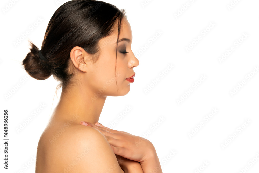 profile of a beautiful young woman gently touches her neck profile of a beautiful young woman gently touches her neck