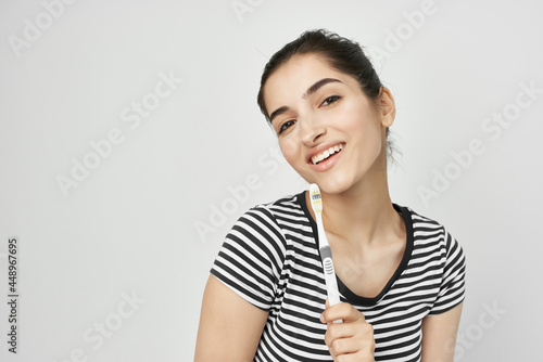 woman in striped t-shirt toothbrush hygiene lifestyle