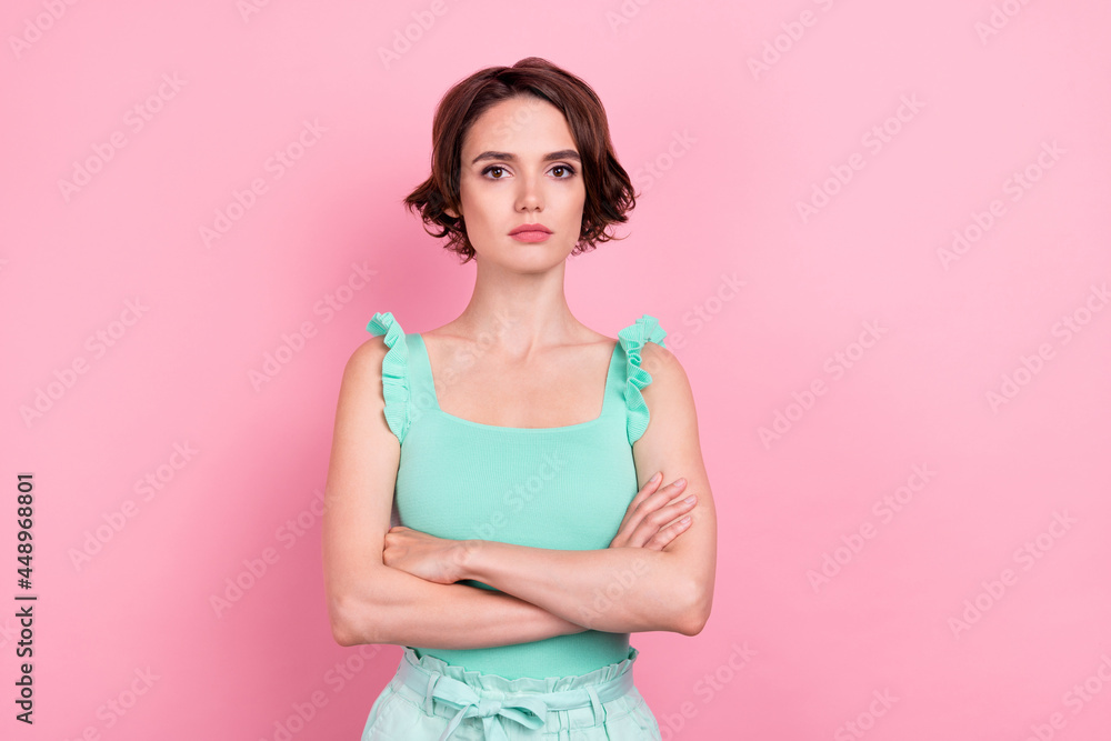 Fototapeta premium Portrait of attractive serious content girl folded arms isolated over pink pastel color background