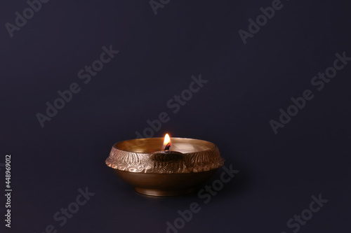 Lit diya lamp on black background. Diwali celebration