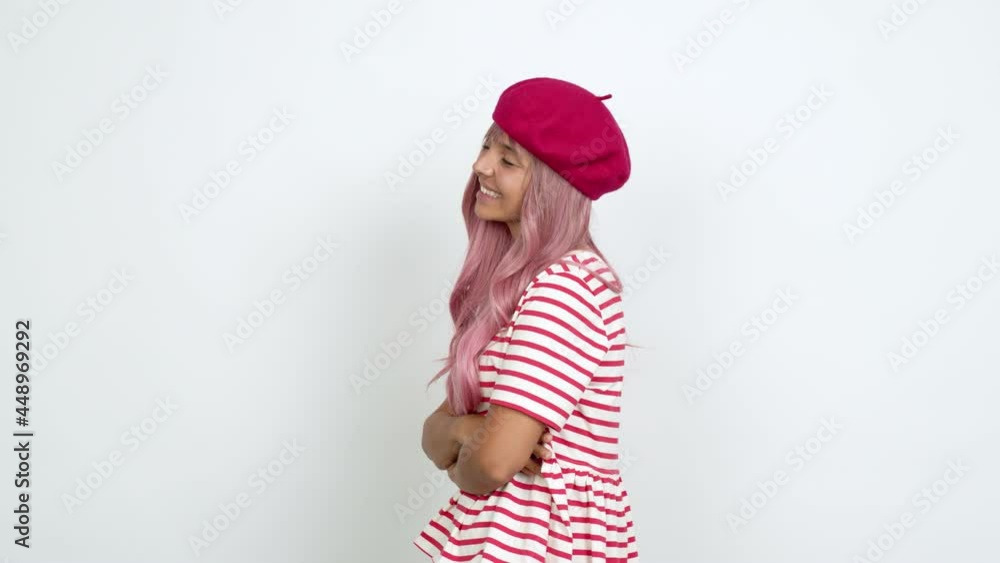 Young woman with pink hair looking side over isolated background Young woman with pink hair looking side over isolated background