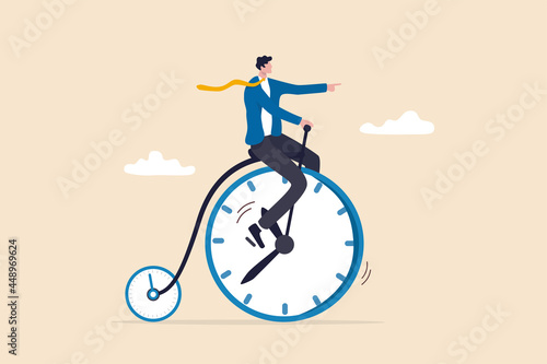 Productivity or efficiency spending time to finish work, time management or work life balance concept, businessman riding vintage bicycle with front wheel as clock and small wheel as stopwatch timer.