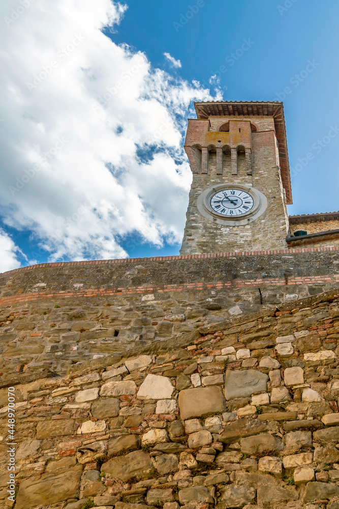 Bottom view of the ancient Clock Tower in the historic center of Passignano sul Trasimeno, Italy