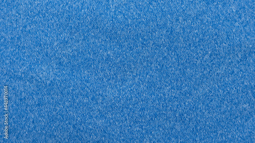 A blue heather knitted fabric textured background made of synthetic fiber.