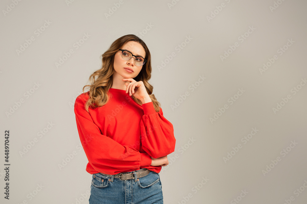 pensive woman in eyeglasses looking away isolated on grey pensive woman in eyeglasses looking away isolated on grey