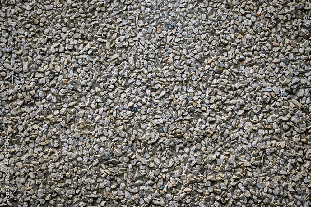A fragment of a wall decorated with gravel close-up A fragment of a wall decorated with gravel close-up