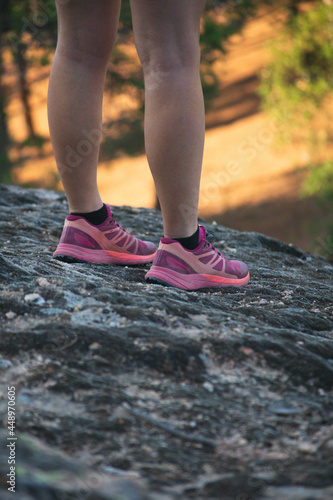 Close up of runner caucasian young woman feet standing in the mountain.