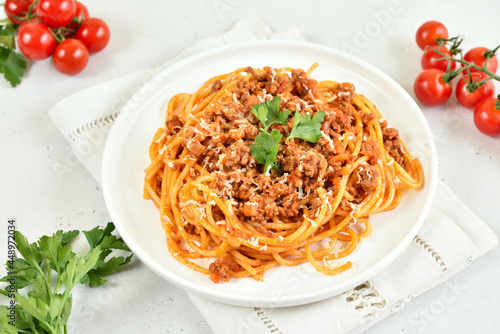 Tasty spaghetti with minced meat and parmesan cheese on plate