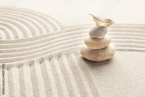 Stacked zen marble stones sand background in mindfulness concept