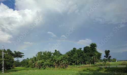 Quadro em tela Rainbow in the beautiful cloudy sky above grees