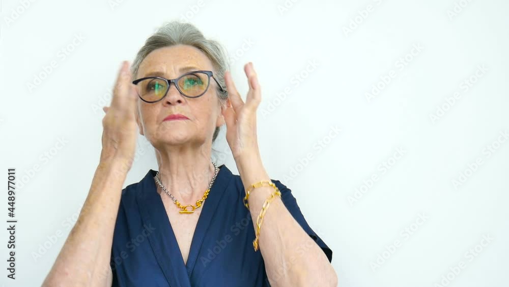 Female portrait of serious grandmother with grey hair and face with wrinkles wearing eyeglasses on white background, mothers day, happy retirement