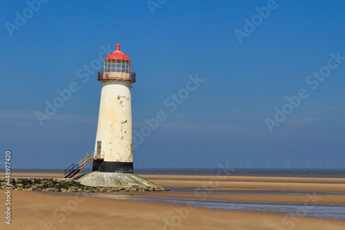 Old lighthouse on the sandy shore. Point of Air  Wales.