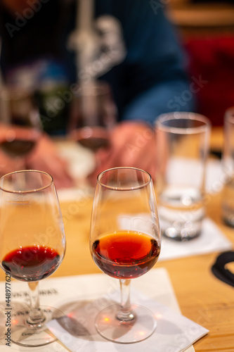 Professional tasting of different fortified dessert ruby, tawny port wines in glasses in porto cellars in Vila Nova de Gaia, Portugal